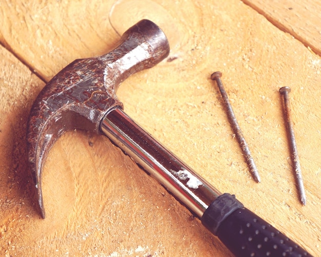 high angle view of hammer on wooden table
