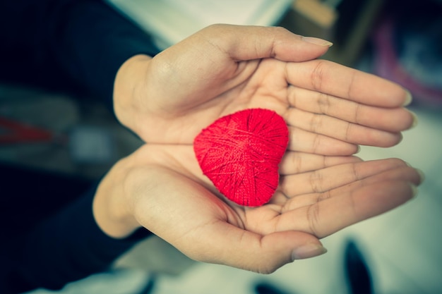 High angle view of hand holding heart shape