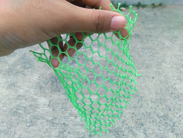 Photo high angle view of hand holding netting