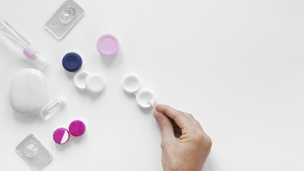 High angle view of hand holding pills against white background