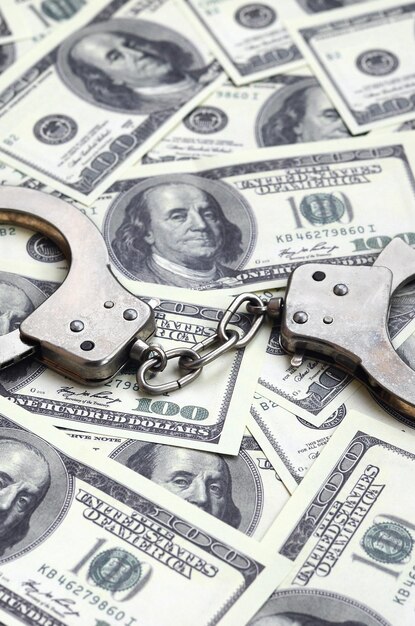 High angle view of handcuffs on us currency