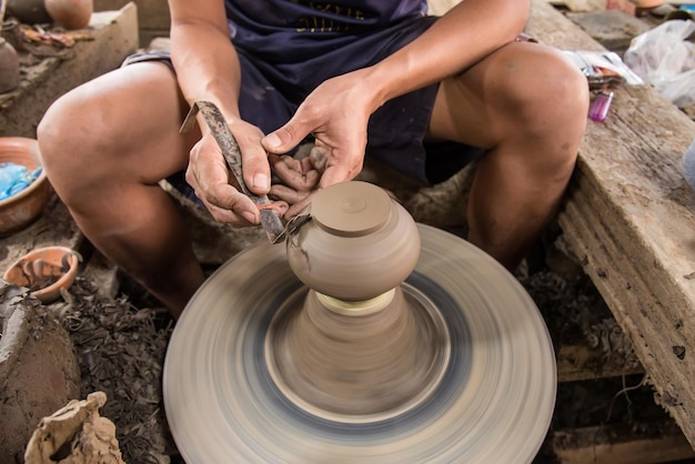 high angle view of hands doing pottery