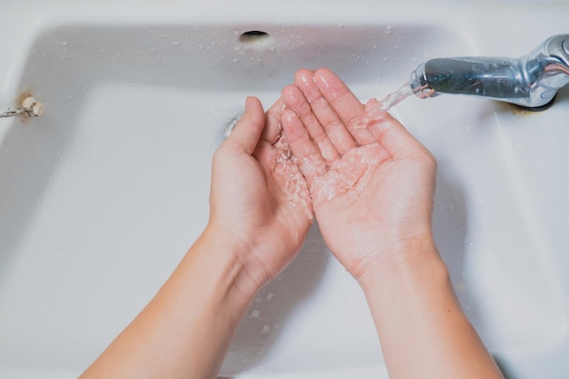 High angle view of hands feet in bathroom