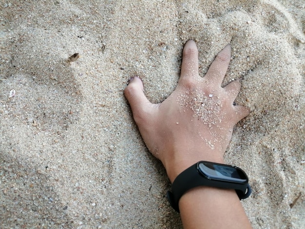 Photo high angle view of hands on sand