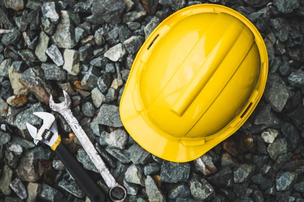 high angle view of hardhat and work tools on stones