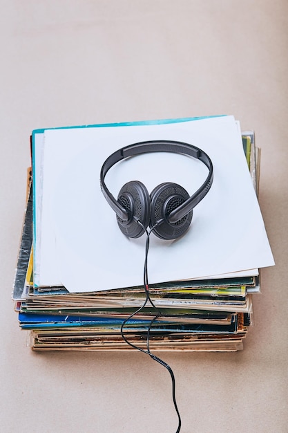 High angle view of headphones on records at table