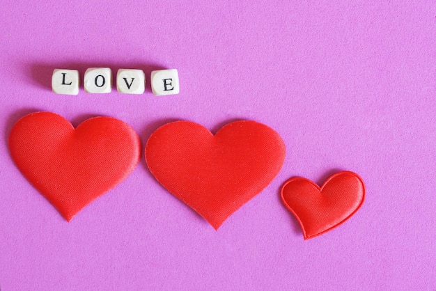 High angle view of heart shape made on pink background