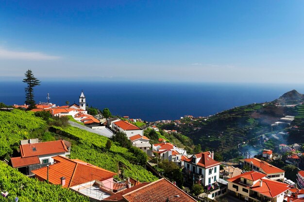 High angle view of houses against blue sky