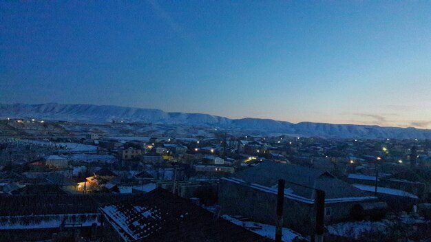 High angle view of houses in town against clear sky