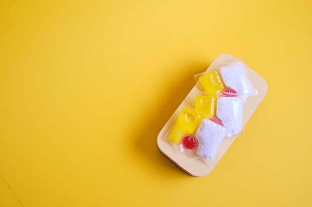 High angle view of ice cream cone on yellow background