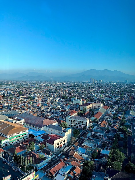 High angle view of illuminated buildings against blue sky