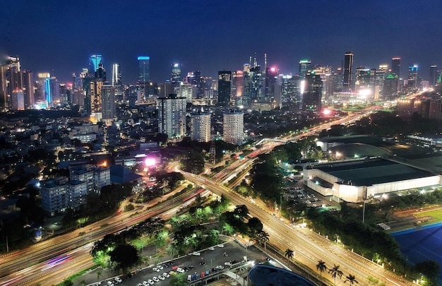 High angle view of illuminated buildings against sky at night