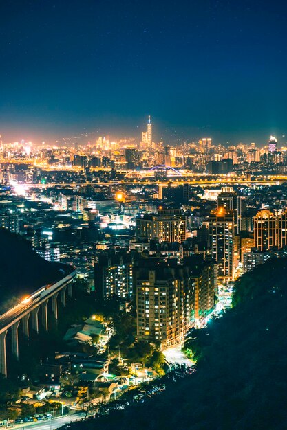 High angle view of illuminated buildings against sky at night