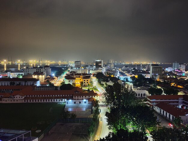 High angle view of illuminated buildings against sky at night