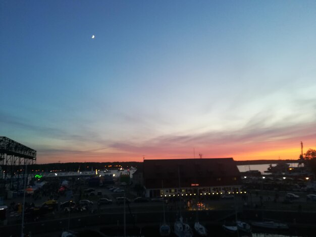 High angle view of illuminated buildings against sky at sunset