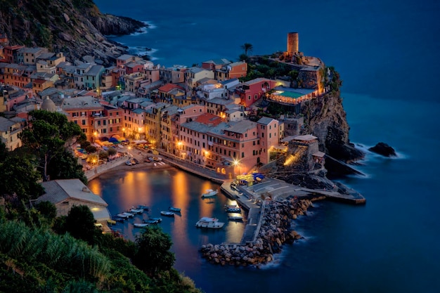 High angle view of illuminated buildings by sea