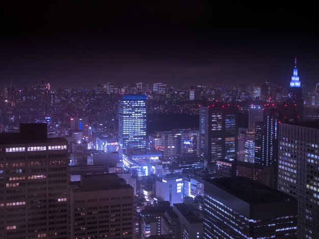 High angle view of illuminated buildings in city at night