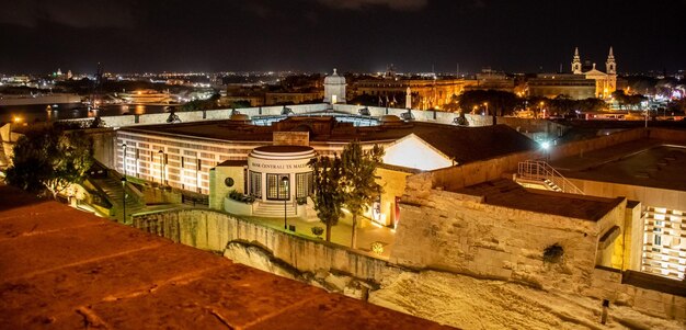 High angle view of illuminated buildings in city at night