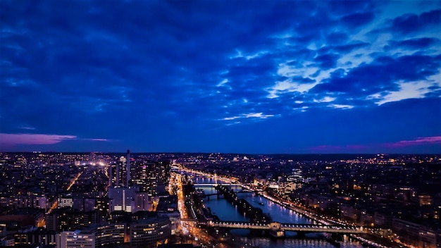 High angle view of illuminated city against cloudy sky at dusk