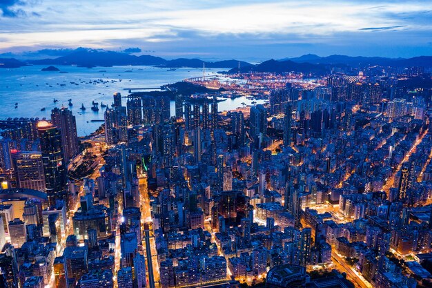 High angle view of illuminated city against sky at dusk