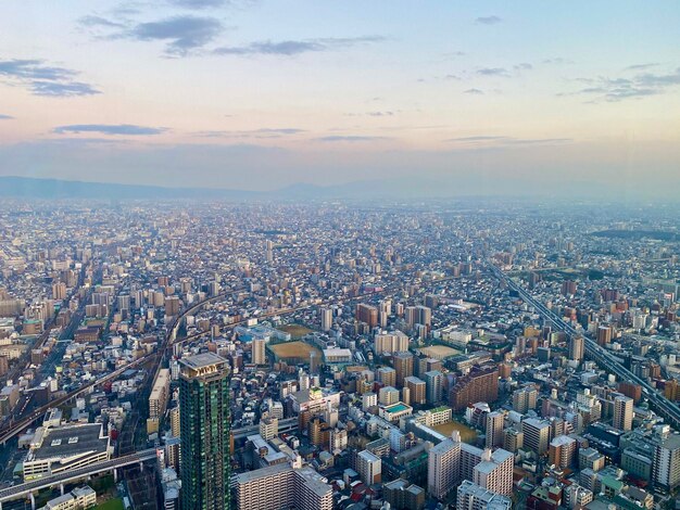 Photo high angle view of illuminated city buildings against sky during sunset