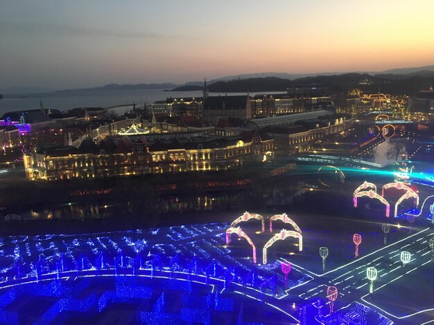 High angle view of illuminated city buildings at night