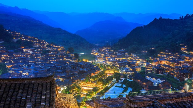 High angle view of illuminated cityscape against sky at night