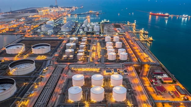 high angle view of illuminated factory by sea