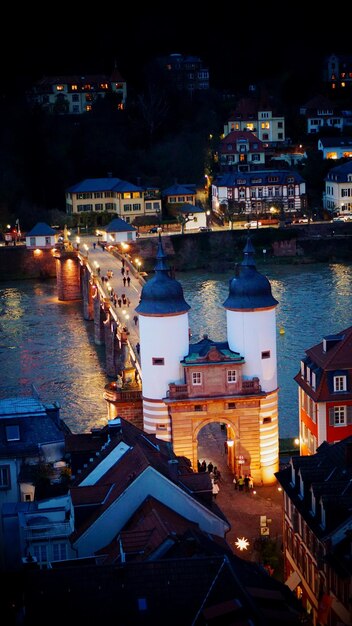 Photo high angle view of illuminated heidelberg old bridge oldbuildings in city at night