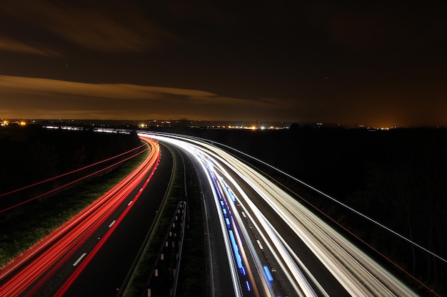 High angle view of illuminated light trails on road at night