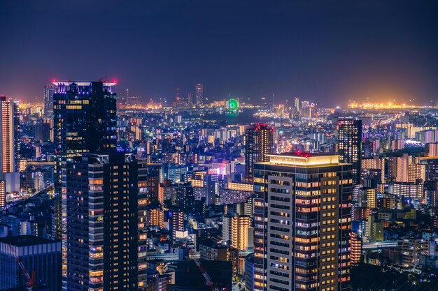 Photo high angle view of illuminated osaka city buildings against sky