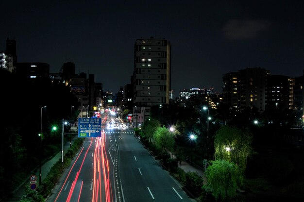 High angle view of illuminated street amidst buildings at night