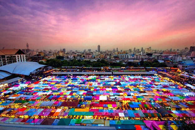 High angle view of illuminated tents in city against sky at sunset