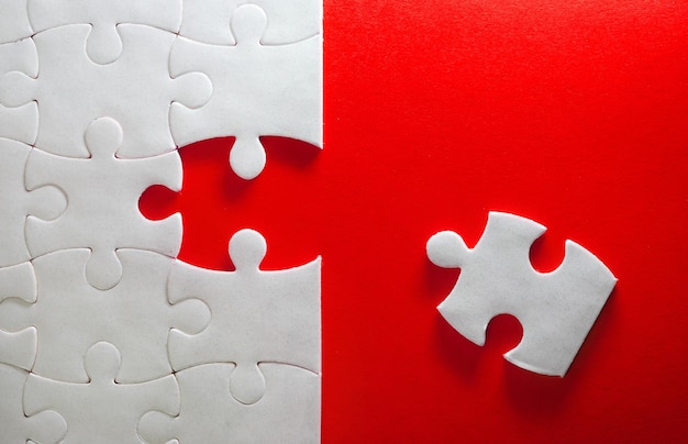 High angle view of jigsaw puzzle over red background