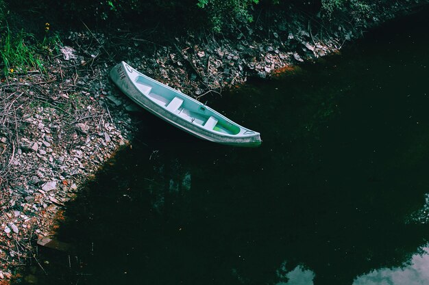 Photo high angle view of kayak moored on riverbank in forest