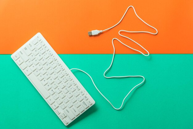 High angle view of keyboard on colored background