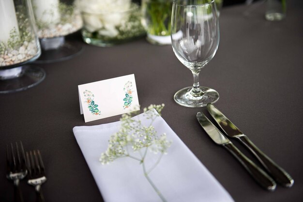 High angle view of label and flower by wineglass on table