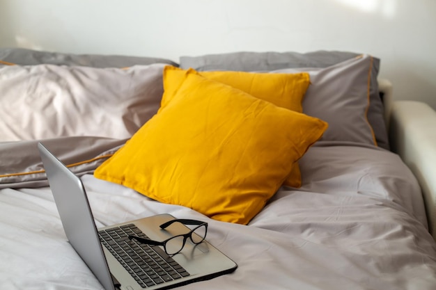 High angle view of laptop on bed at home