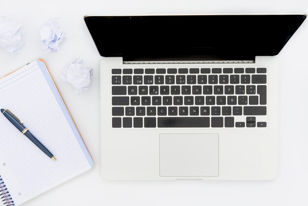 High angle view of laptop and book on table