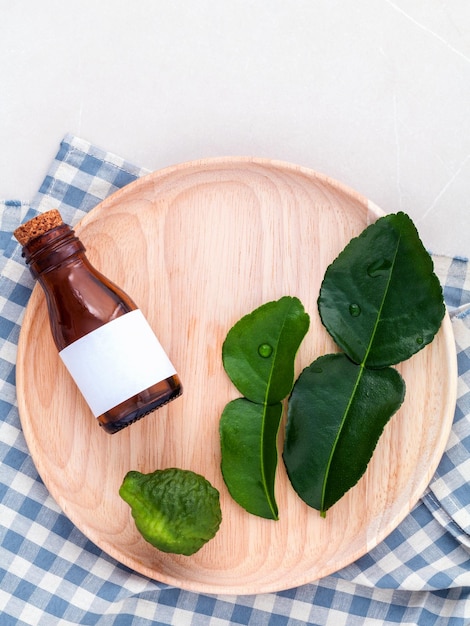 High angle view of leaves and bottle in plate