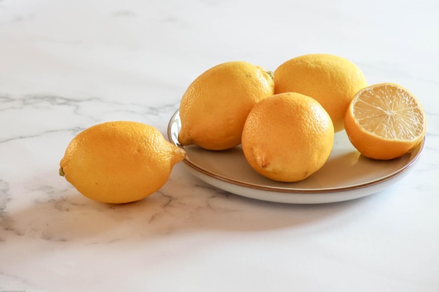 High angle view of lemon fruits in plate on table