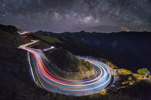 High angle view of light trails on road against sky at night