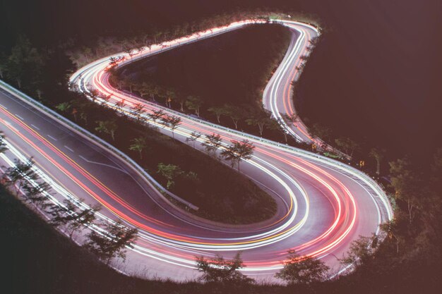 Photo high angle view of light trails on road at night