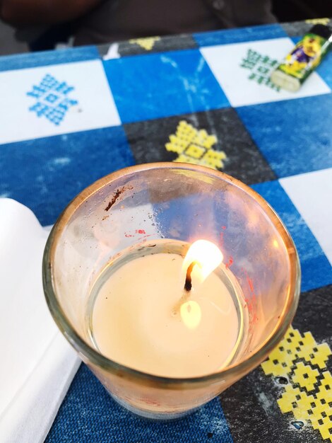 High angle view of lit candles on table