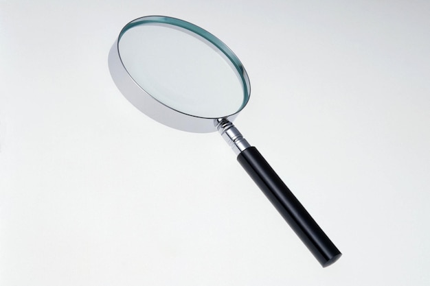 high angle view of magnifying glass against white background