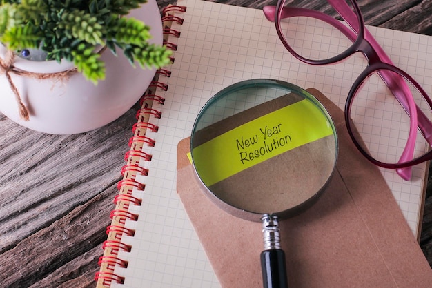 High angle view of magnifying glass on book over table