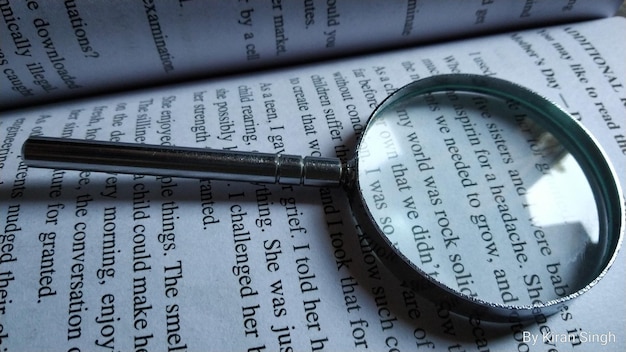 High angle view of magnifying glass on book