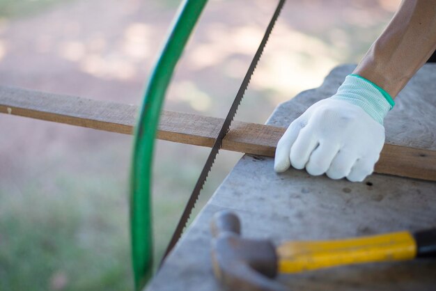high angle view of man cutting block of wood on table