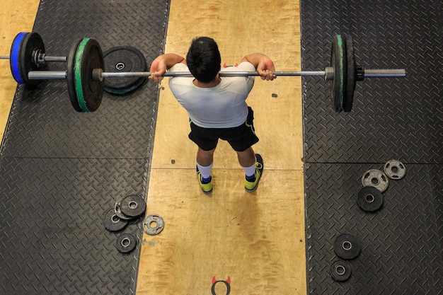 high angle view of a man exercising with barbell