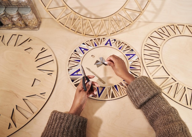 Foto vista ad alto angolo di un uomo che tiene un orologio contro la parete